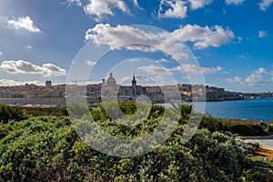 Panoramic view of Valletta Skyline at beautiful sunset from Sliema with churches