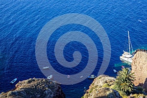 Panoramic view of vast blue mediterranean seascape copy space with light wave, sailing ships and rock mountain foreground