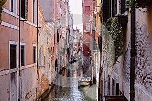 Panoramic view of Venice narrow canal with historical buildings and boat