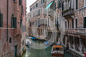 Panoramic view of Venice narrow canal with historical buildings and boat