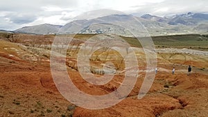 Panoramic view of the very bright red-orange mountains Kyzyl Chin in the Altai Republic in Russia. Journey to Altai Mars.