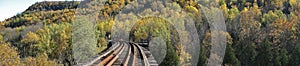 Panoramic view of the vibrant autumn colors with railroad track at Credit River Valley in Caledon, Ontario, Canada photo