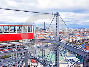 Panoramic view of Vienna and red retro cab from height ferris wheel in Prater Amusement Park, Vienna, Austria