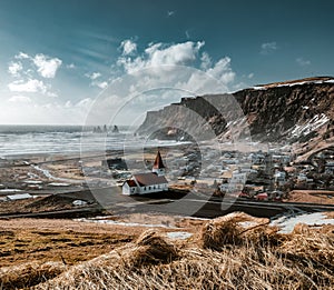 Panoramic view of the Vik at sunrise sunset . South Iceland.Typical red colored wooden church in Vik town, Iceland in