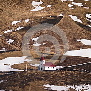 Panoramic view of the Vik at sunrise sunset . South Iceland.Typical red colored wooden church in Vik town, Iceland in