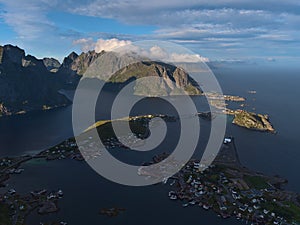 Panoramic view of village Reine with fjord and the rugged mountains of MoskenesÃ¸ya island, Lofoten, Norway.