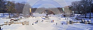 Panoramic view of water fountain covered with fresh winter snow in Central Park, Manhattan, New York City