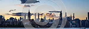 Panoramic view of waterside buildings and towers of NYC at sunset