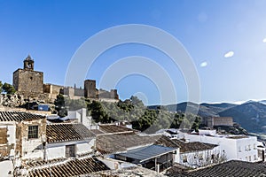 Panoramic view of white houses and tile roofs with the Alcazaba de Antequera in the background