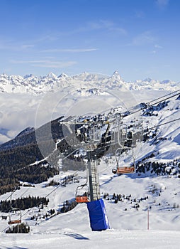 Panoramic view of wide and groomed ski piste in resort of Pila in Valle d`Aosta, Italy during winter