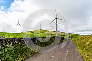 Panoramic view of wind farm or wind park, with high wind turbines for generation electricity with copy space.