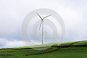 Panoramic view of wind farm or wind park, with high wind turbines for generation electricity.