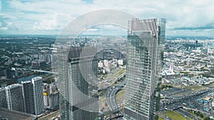 Panoramic view from window of business center of city and cloudy sky. Action. Top view of panorama of business center of