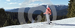 Panoramic view woman skier with backpack and winter mountains nature background. Ski resort Pamporovo, Bulgaria