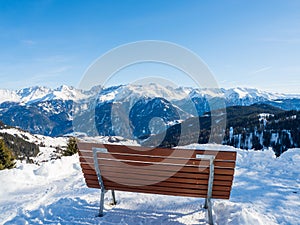 Panoramic view with wood bench in winter in resort Ladis, Fiss, Serfaus in ski resort in Tyrol