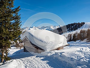Panoramic view with wood house in winter in resort Ladis, Fiss, Serfaus in ski resort in Tyrol