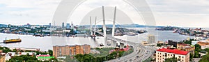 Panoramic view on the Zolotoy Golden Bridge is cable-stayed bridge across the Zolotoy Rog or Golden Horn in Vladivostok photo