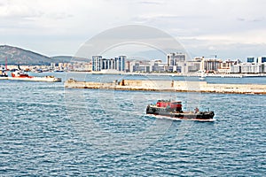 Panoramic views of the port and the city of Gibraltar during day and night. Kind of carg o and merchant vessels anchored.