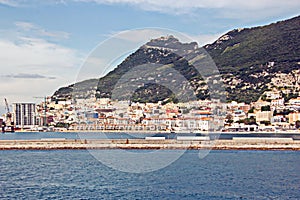 Panoramic views of the port and the city of Gibraltar during day and night. Kind of carg o and merchant vessels anchored..