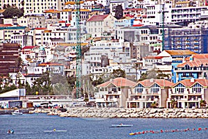 Panoramic views of the port and the city of Gibraltar during day and night. Kind of carg o and merchant vessels anchored.