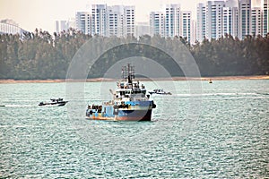 Panoramic views of the port and the city of Singapore during day and night. Kind of cargo and merchant vessels anchored.