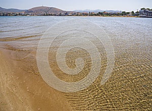 Panoramic views of the sandy beach,  mountains  the island of Evia on Liani Ammos beach in Halkida, Greece on a Sunny summer day