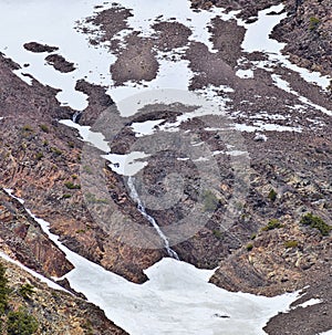 Panoramic Views of Wasatch Front Rocky Mountains from Little Cottonwood Canyon in early spring with melting snow, pine trees and b