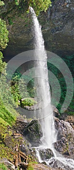 Panoramic waterfall cascading on rocks in vertical position