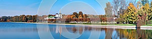 Panoramic wide angle view of pond reflections of historic Kuskovo buildings and sunny autumn park