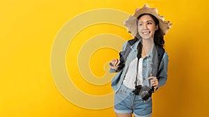 Panoramic wide banner. happy asian  woman traveler with backpack and hat in casual clothing smiling over copy space yellow color b