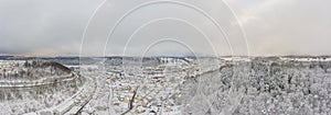 Panoramic wide white view over a winter cityscape with a town in the center