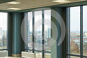 Panoramic windows in an empty spacious room. Installation of fiberglass windows in the business center