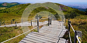 Panoramic wooden pedestrian walking pathway in puy-de-dome french mountain chain volcano