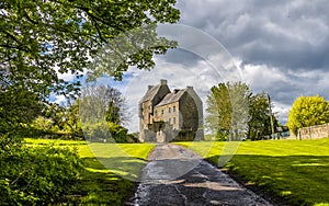 A panorma view up a farm track towards Midhope castle, Scotland