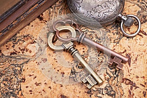 Panta rhei concept: Antique pocket watch, vintage keys and pile of old books on natural cork