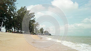 Pantai Puteri beach: daytime waves on sandy shore