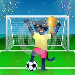 A panther in uniform standing on the ball and cheering with goblet on the soccer field