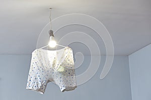 The panties are hanging on the chandelier. Mystical omen and sorcery to attract money. Copy space.
