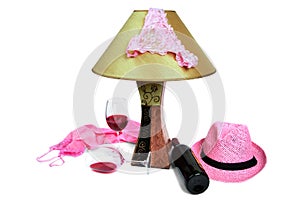 Panties on the lamp near the bottle of wine and two glasses