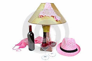 Panties on the lamp near the bottle of wine and two glasses photo