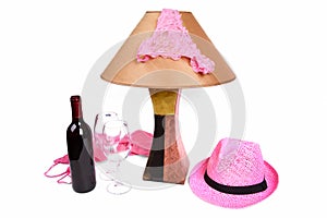 Panties on the lamp near the bottle of wine and two glasses photo