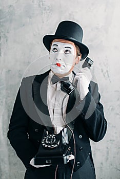 Pantomime actor performing with retro telephone