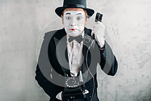 Pantomime actor performing with retro telephone