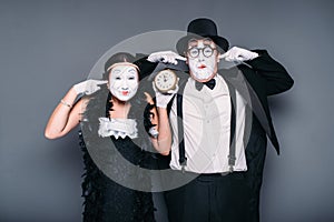 Pantomime actors performing with alarm clock