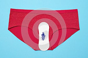 Pants with pad and drop from beads on blue background