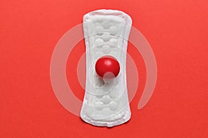 Panty liners on a red background with an abstract spot of blood