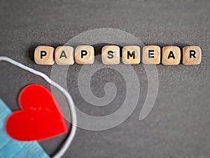 Pap smear text on wooden cubes background. Women health care awareness concept.