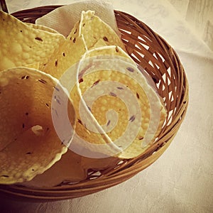 Papadum bread in a wood basket