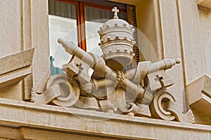 Papal regalia and insignia on the building at St. Peter square,