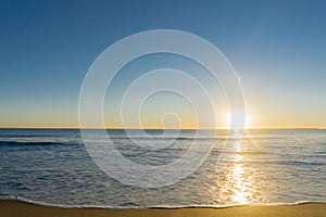 Papamoa Beach, outlok to horizon golden glow into into sunris